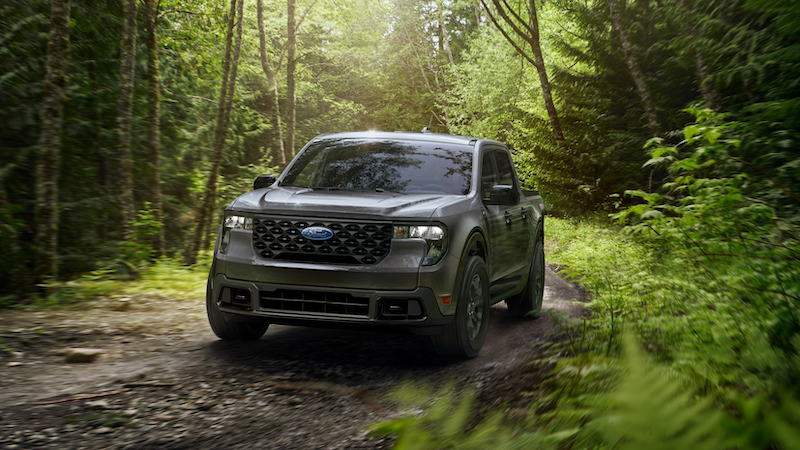 Carbonized Gray 2026 Ford Maverick XLT navigating off-road path near Huntington, WV — compact pickup with all-terrain capability